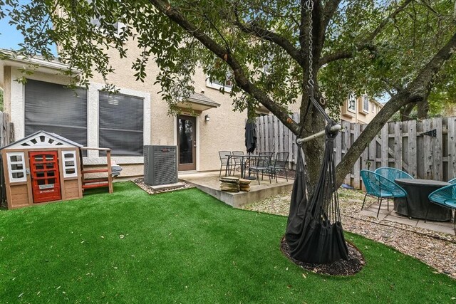 view of yard with cooling unit and a patio