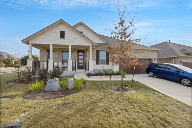 317 Barley Fork Ln, Hutto, TX 78634 - view of front of house featuring covered porch, a front yard, a garage, brick siding, and concrete driveway