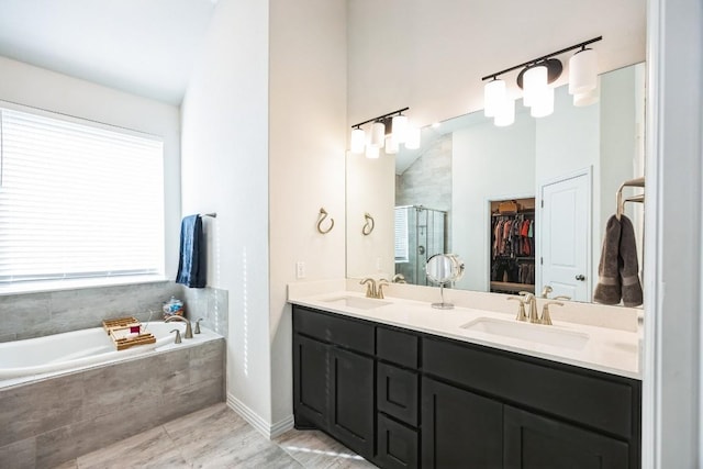 317 Barley Fork Ln, Hutto, TX 78634 - full bathroom with a garden tub, a sink, a stall shower, and double vanity