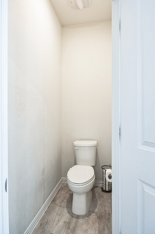 317 Barley Fork Ln, Hutto, TX 78634 - bathroom with baseboards, toilet, wood finished floors, and visible vents