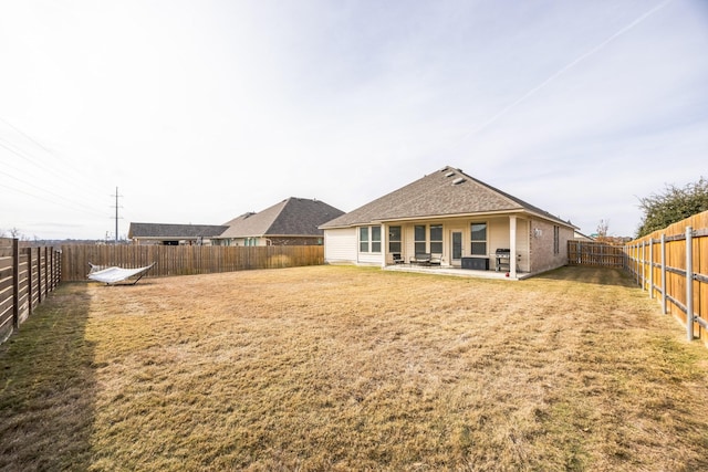 back of property featuring a patio and a lawn