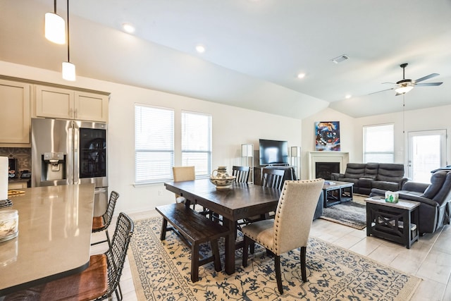 dining area with ceiling fan, light hardwood / wood-style floors, and lofted ceiling