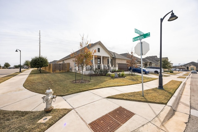 view of front of home featuring covered porch and a front yard