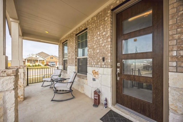 317 Barley Fork Ln, Hutto, TX 78634 - view of exterior entry featuring brick siding and covered porch