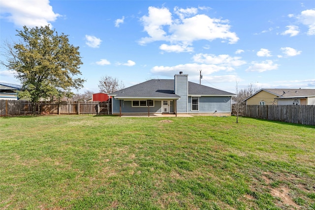 rear view of house with a patio area and a lawn