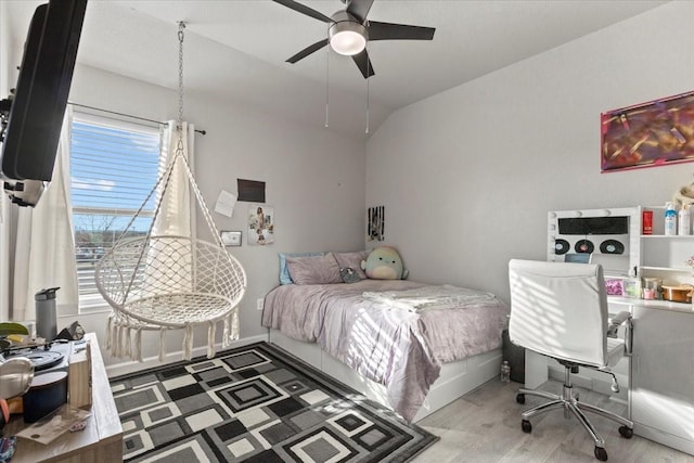 bedroom featuring hardwood / wood-style flooring, ceiling fan, and vaulted ceiling