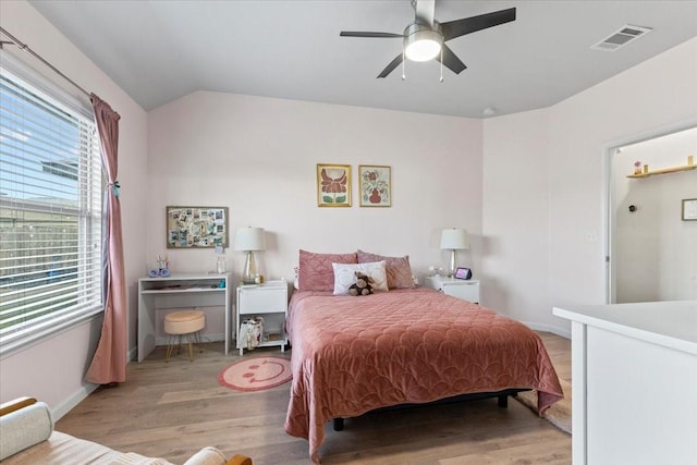 bedroom with ceiling fan, light hardwood / wood-style flooring, and lofted ceiling