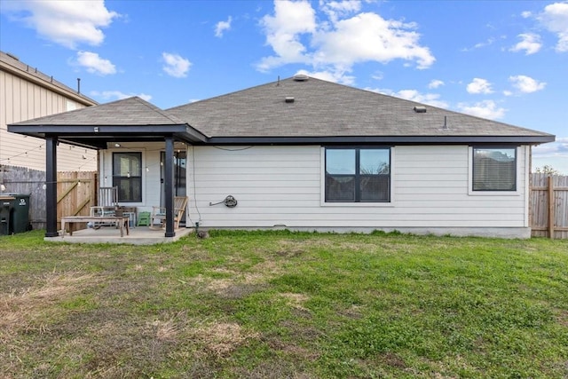 back of house featuring a patio and a lawn