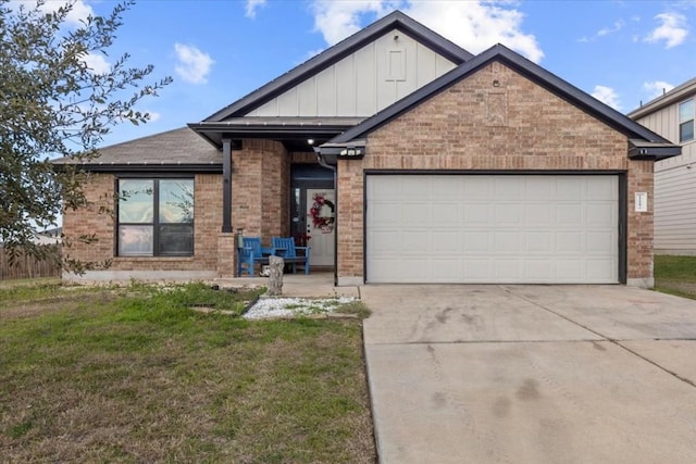 view of front of property with a garage, brick siding, concrete driveway, board and batten siding, and a front yard