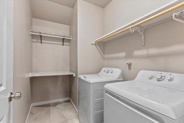 washroom featuring washer and dryer and light tile patterned floors