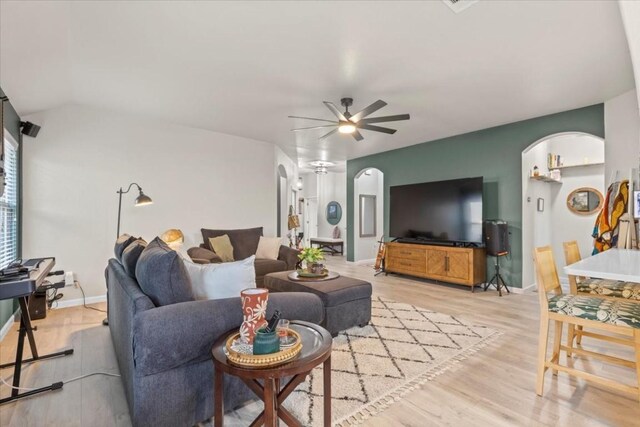 living room featuring ceiling fan and light hardwood / wood-style flooring