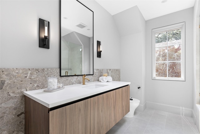 bathroom with tile patterned flooring, vanity, and toilet