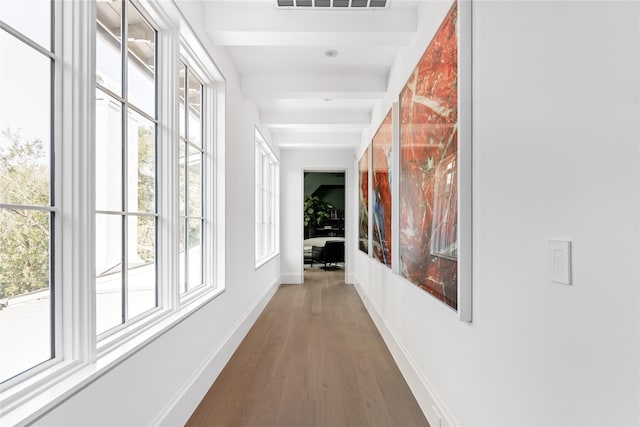 corridor with dark wood-type flooring and beam ceiling