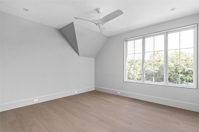 bonus room featuring vaulted ceiling, ceiling fan, a wealth of natural light, and light wood-type flooring