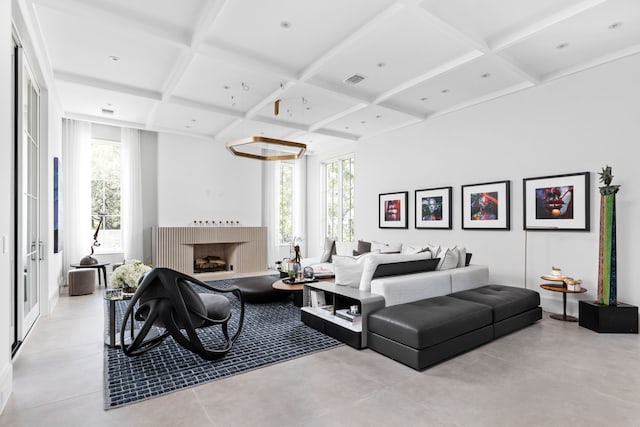 living room featuring beamed ceiling and coffered ceiling