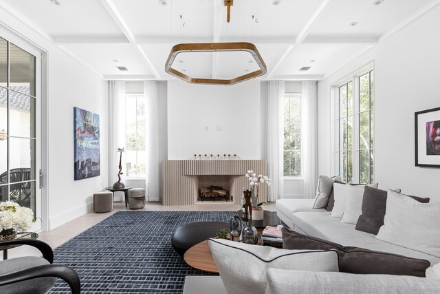 living room featuring beam ceiling and coffered ceiling