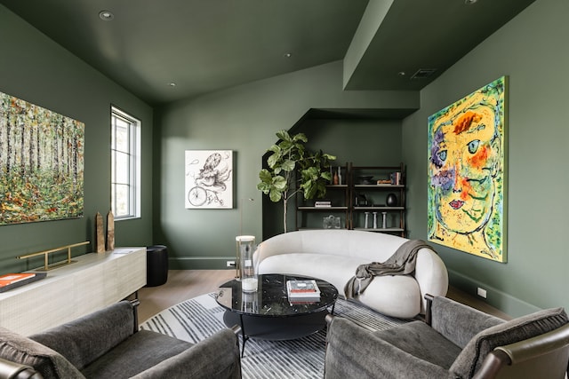 living room with hardwood / wood-style floors and lofted ceiling