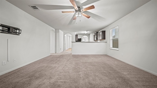 unfurnished living room featuring ceiling fan and light carpet