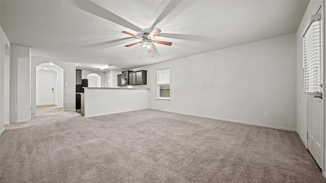 unfurnished living room with ceiling fan and light carpet