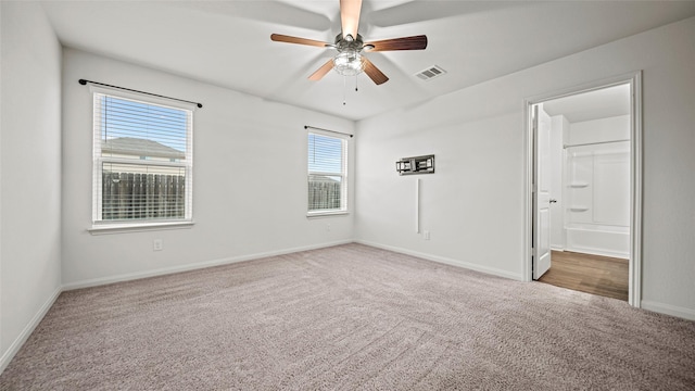 carpeted empty room featuring ceiling fan