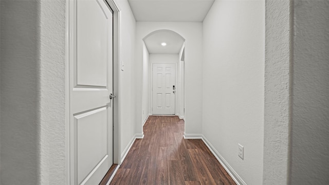 hallway with dark hardwood / wood-style floors