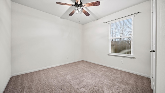 empty room featuring ceiling fan and carpet