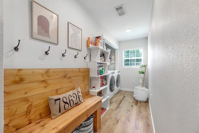 407 S Pine St, Georgetown, TX 78626 - washroom with separate washer and dryer, light wood-type flooring, baseboards, and a textured wall