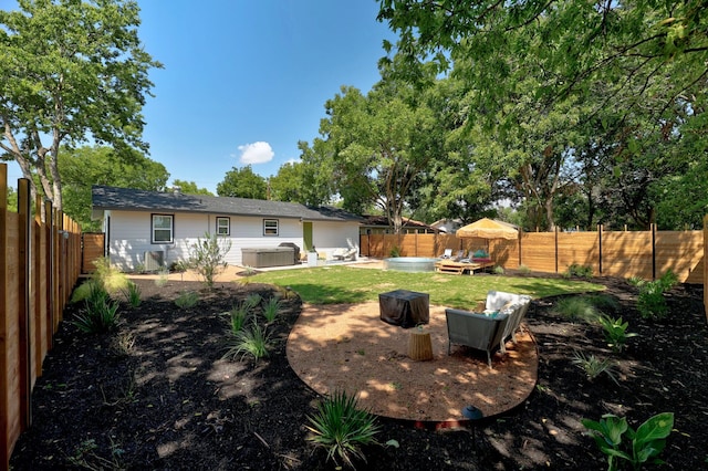 view of yard featuring a hot tub, cooling unit, and an outdoor fire pit