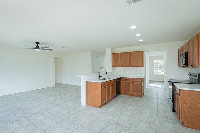 kitchen with kitchen peninsula, black appliances, backsplash, ceiling fan, and sink