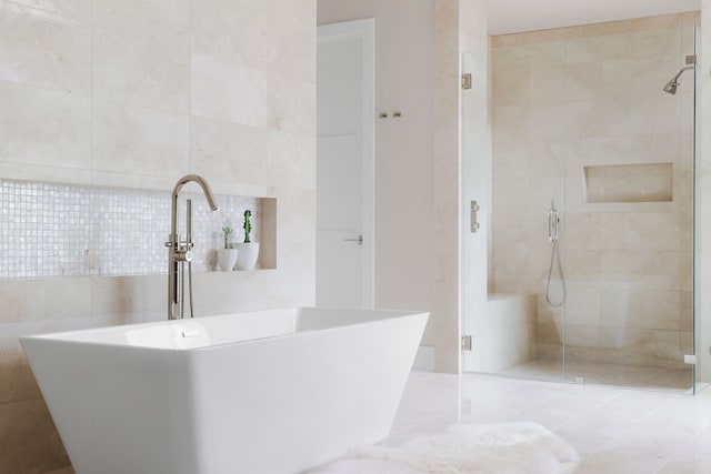 bathroom featuring sink, tile walls, and separate shower and tub