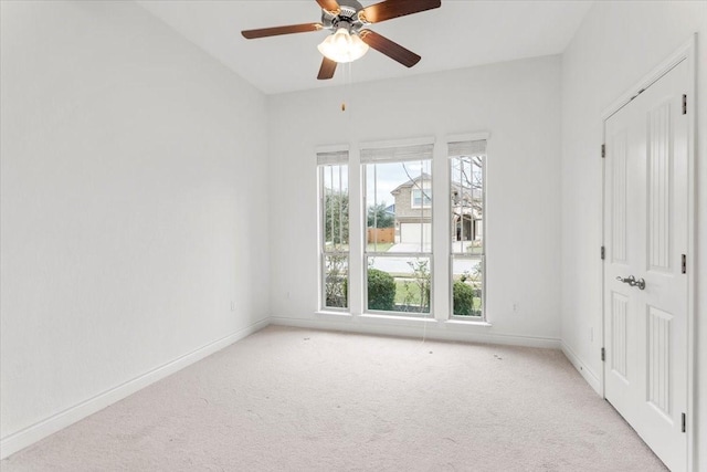 unfurnished room featuring ceiling fan, a healthy amount of sunlight, and light colored carpet