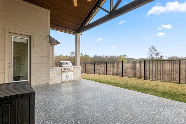 view of patio featuring exterior kitchen, ceiling fan, and a grill