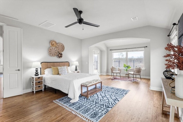 bedroom with dark hardwood / wood-style flooring, ceiling fan, and vaulted ceiling