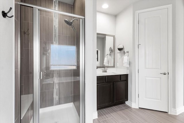 bathroom featuring an enclosed shower and vanity