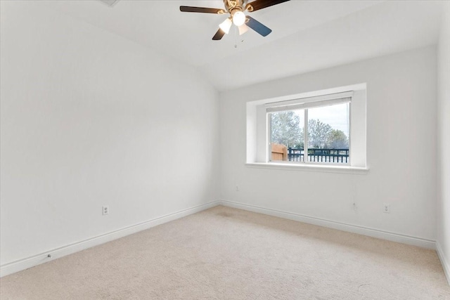 spare room featuring ceiling fan, lofted ceiling, and carpet flooring