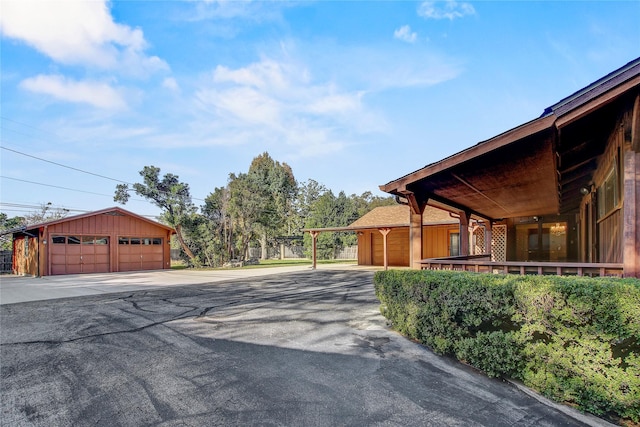 exterior space with a garage and an outbuilding