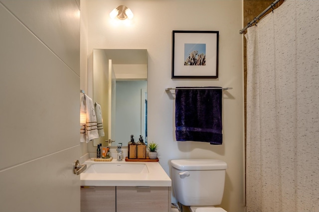 bathroom featuring vanity and toilet