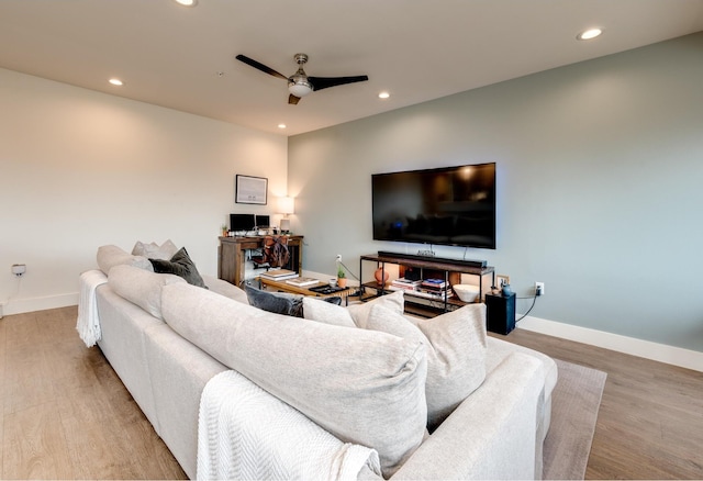 living room featuring light wood-type flooring and ceiling fan