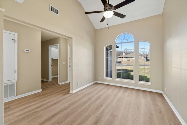 spare room featuring high vaulted ceiling, ceiling fan, and light hardwood / wood-style flooring