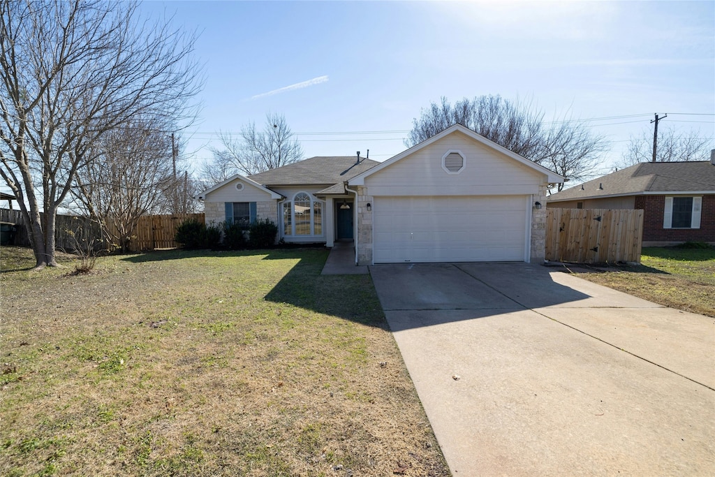 single story home featuring a garage and a front yard