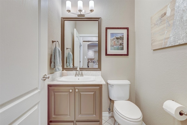 bathroom featuring toilet, tile patterned floors, and vanity