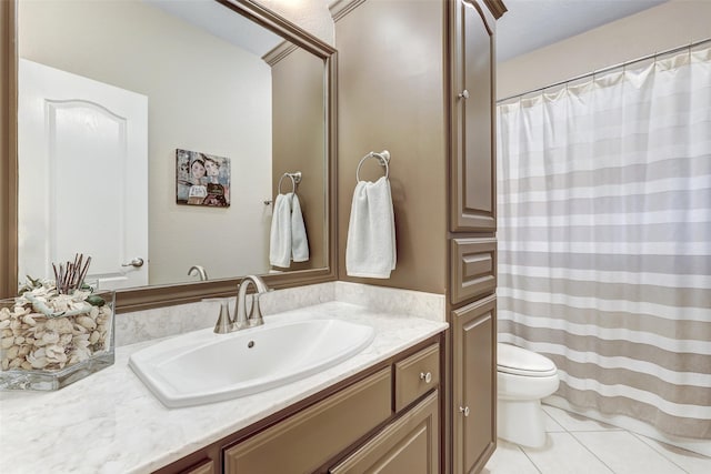 bathroom with tile patterned floors, vanity, and toilet