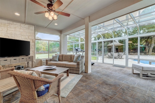 sunroom featuring ceiling fan