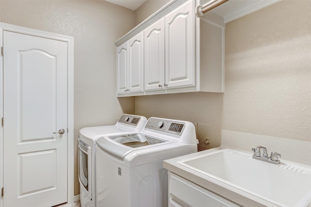 laundry room with washer and dryer, sink, and cabinets