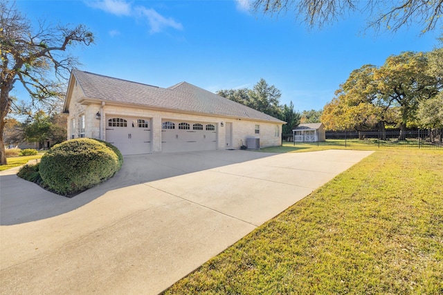 view of side of home featuring central AC unit, a lawn, and a garage