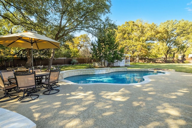 view of swimming pool with a yard, an outbuilding, and a patio