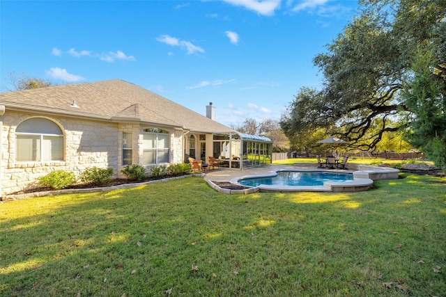 view of pool with a patio and a lawn