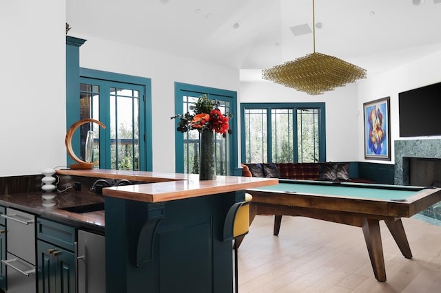 playroom featuring pool table, vaulted ceiling, light hardwood / wood-style flooring, and a wealth of natural light