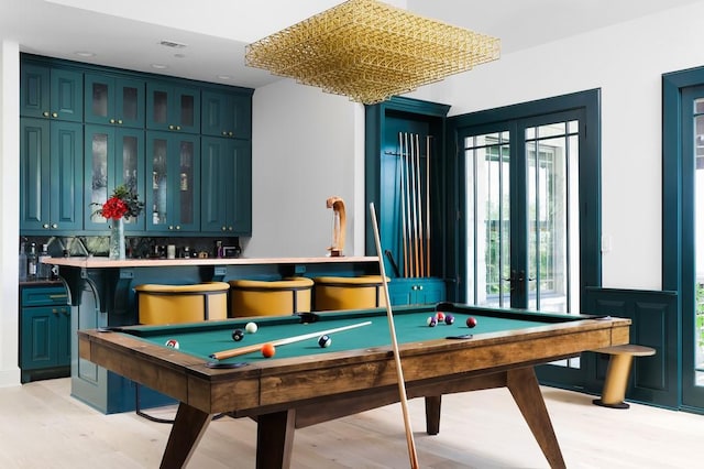 recreation room with pool table, light hardwood / wood-style floors, french doors, and plenty of natural light