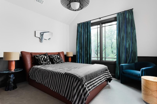 bedroom featuring lofted ceiling, carpet flooring, and multiple windows